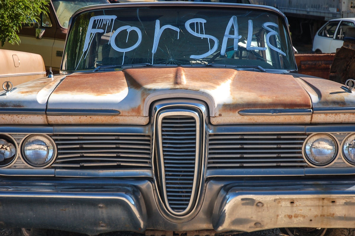 shutterstock 359935604 classic American car for sale Edsel clunker in junkyard