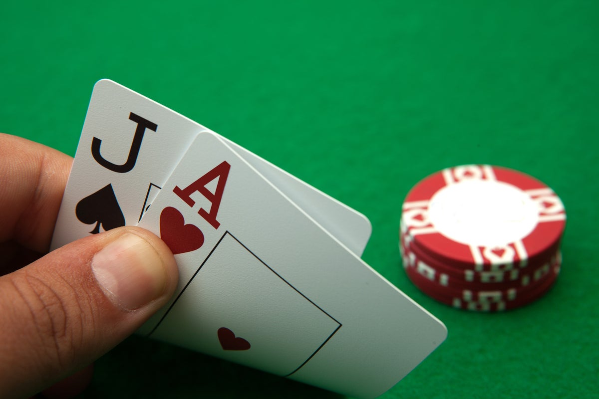 shutterstock 610036778 casino table with cards showing blackjack hand 21 jack and ace