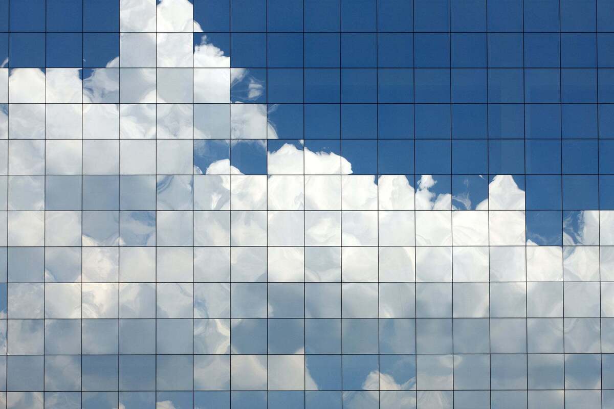 pixelated clouds reflecting on building windows